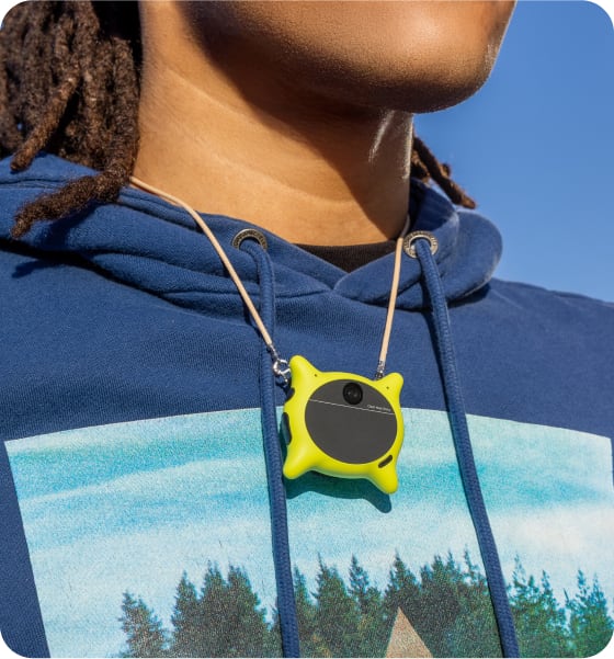 Person wearing Looki device with landscape hoodie